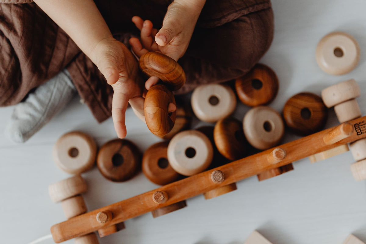 A child stacking wooden blocks